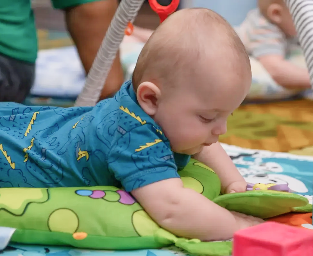 infant learning to lay on stomach
