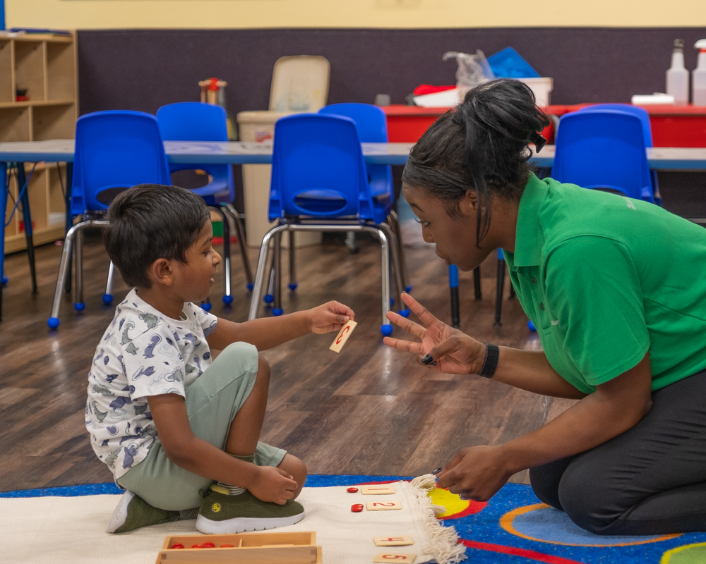 child counting with teacher